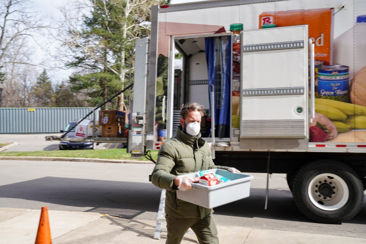 Volunteer delivers groceries from the My Neighborhood Mobile Grocery truck.