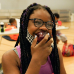 Food Distribution in Schools Girl Eating Apple COVID News